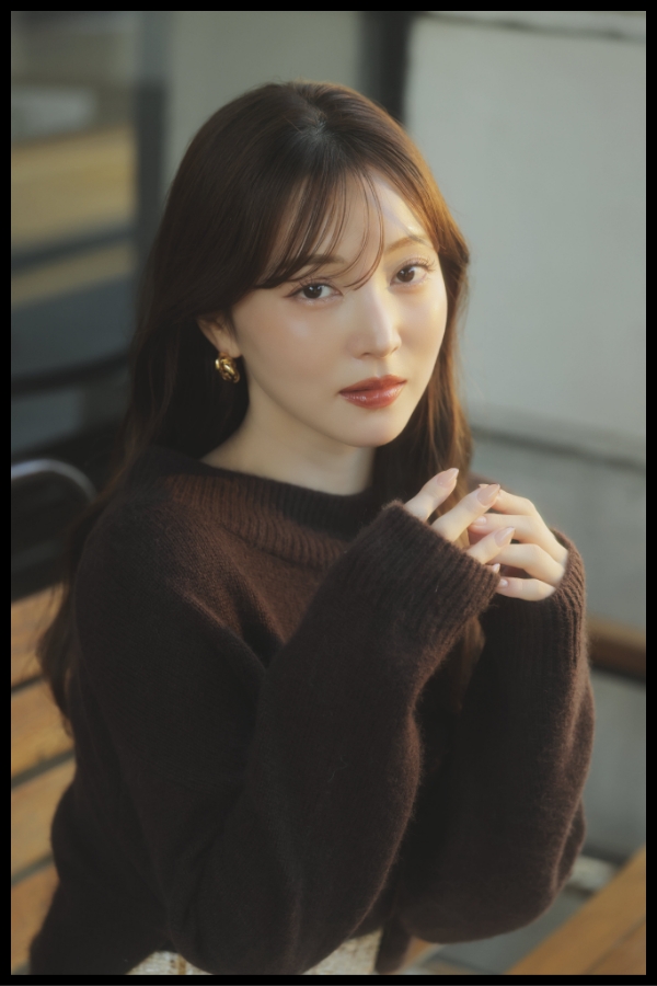 2WAYアンゴララクーン混ニット・ベロアラインツイードミニスカート・ロングブーツ・カーブラインボストンバッグ・ノットモチーフピアスを着用した女性